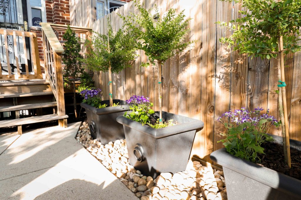 Large Planters along Fence with Rocks