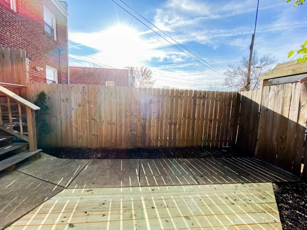Before Photo of Backyard Along Fence
